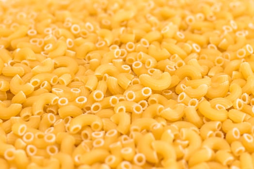 Uncooked Chifferi Rigati Pasta Background. Fat and Unhealthy Food. Classic Dry Macaroni Texture. Italian Culture and Cuisine. Raw Pasta photo