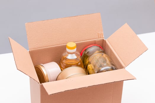 Food Reserves or Donation Box. Carton Box with Canned Food, Cereals and Grocery. Emergency Food Storage in Case of Crisis. Free Social Help, Blessings and Care. Strategic Food Supplies photo