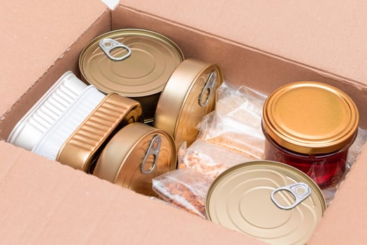Food Reserves or Donation Box. Carton Box with Canned Food, Cereals and Grocery. Emergency Food Storage in Case of Crisis. Free Social Help, Blessings and Care. Strategic Food Supplies photo
