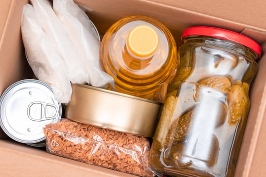 Food Reserves or Donation Box. Carton Box with Canned Food, Cereals and Grocery. Emergency Food Storage in Case of Crisis. Free Social Help, Blessings and Care. Strategic Food Supplies photo