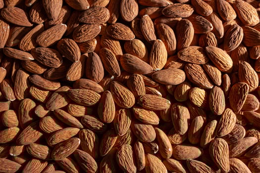 Scattered Almonds. Background from Almond Nuts. Natural High-Calorie Snacks photo