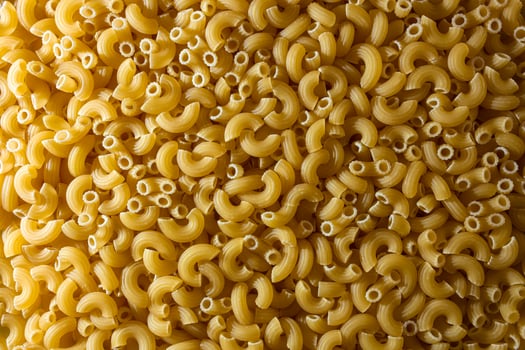 Uncooked Chifferi Rigati Pasta. A Culinary Canvas of Chifferi Rigati, Creating a Lively and Textured Background for Gourmet Cooking. Dry Pasta. Raw Macaroni - Top View, Flat Lay photo