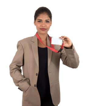 Smiling business woman holding a blank business card or ID card over white background photo
