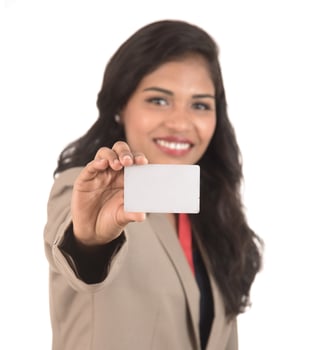 Smiling business woman holding a blank business card or ID card over white background photo
