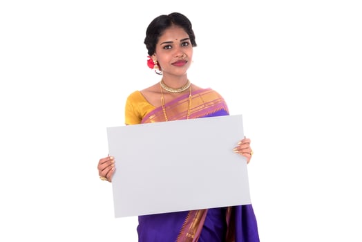 Traditional Girl holding and showing blank white sign board photo