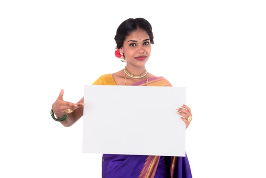 Traditional Girl holding and showing blank white sign board photo