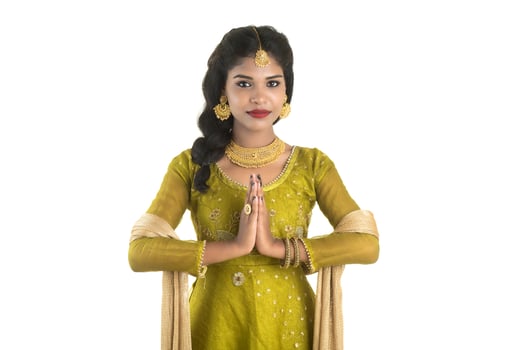 Beautiful Indian girl with welcome expression inviting, greeting Namaste photo