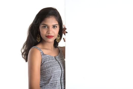 Beautiful young Girl holding white big signboard and posing photo