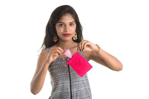 Close-up of young girl hands holding menstrual cup, Gynaecology concept, Showing thumbs up approving the use of the menstrual cup photo