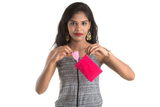Close-up of young girl hands holding menstrual cup, Gynaecology concept, Showing thumbs up approving the use of the menstrual cup photo