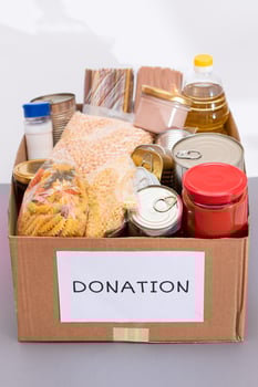 Donation Box of Free Food. Carton Box with Canned Food, Cereals and Grocery. Meal Reserves. Emergency Food Storage in Case of Crisis. Free Social Help, Blessings and Care. Strategic Food Supplies photo
