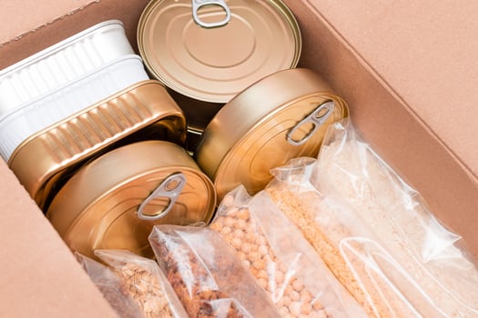 Food Reserves or Donation Box. Carton Box with Canned Food, Cereals and Grocery. Emergency Food Storage in Case of Crisis. Free Social Help, Blessings and Care. Strategic Food Supplies photo