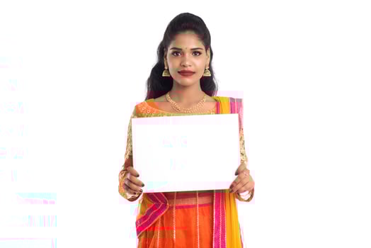 Traditional Girl holding and showing blank white sign board photo