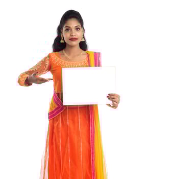 Traditional Girl holding and showing blank white sign board photo