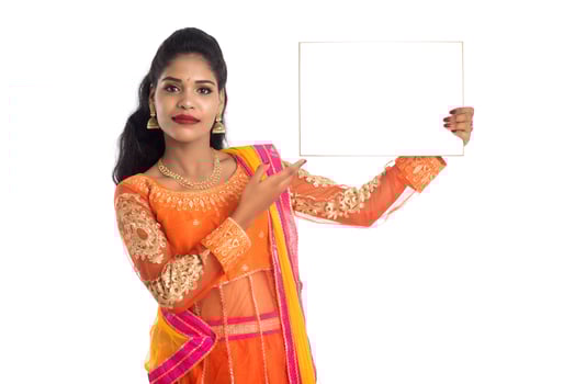 Traditional Girl holding and showing blank white sign board photo