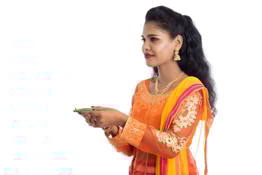 Portrait of a Indian Traditional Girl holding Diya, Girl Celebrating Diwali or Deepavali with holding oil lamp during festival of light on white background photo
