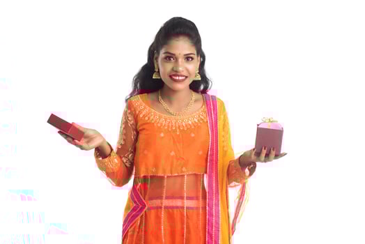 Portrait of young happy smiling Indian Girl holding gift boxes on a white background. photo