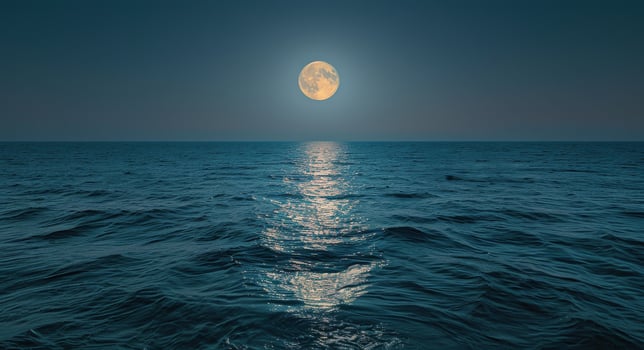 Full Moon Shining on a Calm Ocean at Night photo