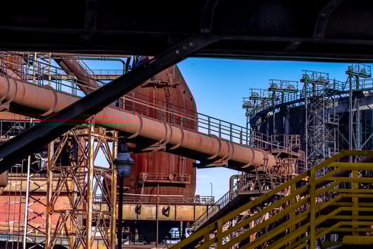 Rusty industrial pipeline crossing between buildings in zollverein coal mine industrial complex photo