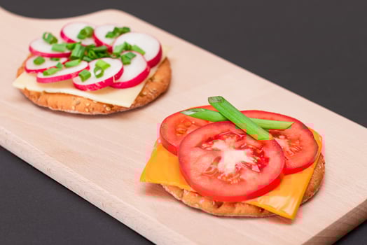 Different Cracker Sandwiches with Tomato, Cucumber, Radish and Cheese on Cutting Board. Easy Breakfast. Diet Food. Quick and Healthy Sandwiches. Crispbread with Tasty Filling. Healthy Dietary Snack photo