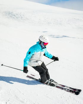 Expert skier on the slopes in Winter snowy mountains sunny day outdoors carve spray snow. Skills and professional skiing instructor photo
