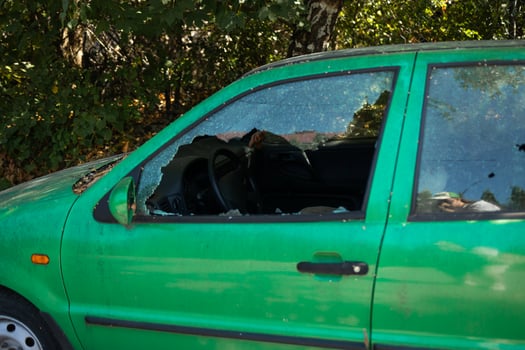 A criminal incident. Hacking the car. Broken left side window of a car photo