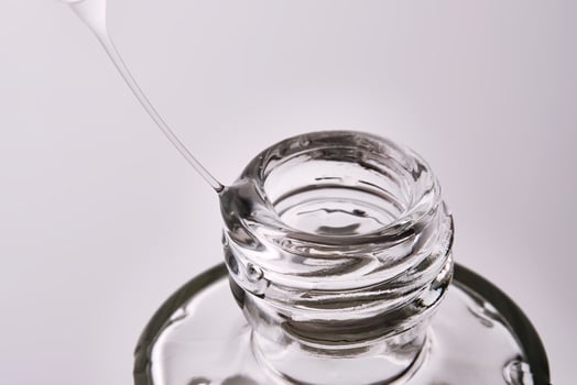 Close-up of a cosmetic bottle with a pipette showing the texture of the serum. photo