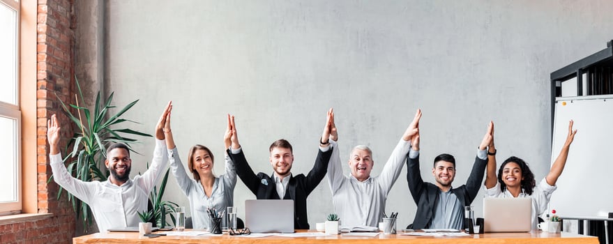 United Business Team. Coworkers Giving High-Five Celebrating Business Success Sitting At Desk In Modern Office. photo