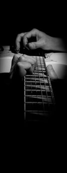 Guitarist Playing Guitar In Studios Low key of man hand play white electric guitar for songs and cover music or skill practice. Close up of musician playing guitars instrument against black background photo