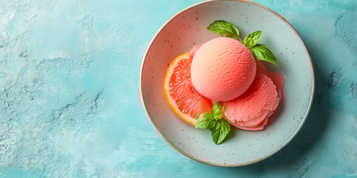 Grapefruit sorbet palate cleanser between meal courses on fine china photo
