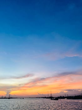 Aerial view to sunset on the river at summer evening with cloudy sky. photo