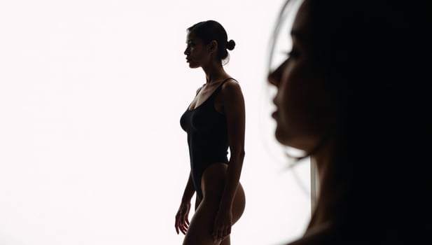 AfricanAmerican woman portrayed as a stylized silhouette on a white studio backdrop photo