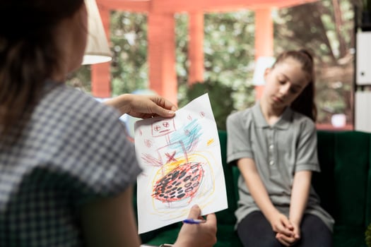 Teenager reveals troubling artwork during a counseling session. Disturbing sketches highlight internal frustration, violent thoughts and emotional distress. Mental health issues. photo