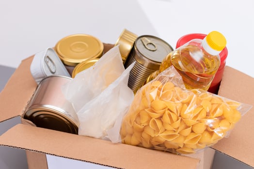Donation Box of Free Food. Carton Box with Canned Food, Cereals and Grocery. Meal Reserves. Emergency Food Storage in Case of Crisis. Free Social Help, Blessings and Care. Strategic Food Supplies photo