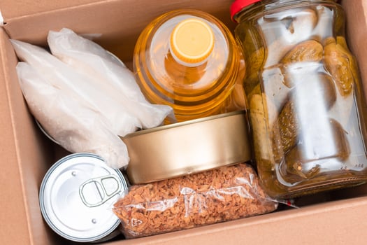 Food Reserves or Donation Box. Carton Box with Canned Food, Cereals and Grocery. Emergency Food Storage in Case of Crisis. Free Social Help, Blessings and Care. Strategic Food Supplies photo