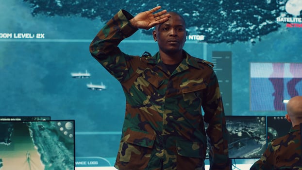 Standing at attention, the soldier executes the military salute gesture to present his respect and devotion as captain of the crew. Patriot army general saluting with right hand to his temple. Camera A. photo