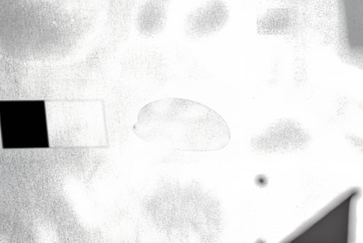 An abstract texture with an overexposed appearance, showing faint shadows in soft, indistinct forms. photo