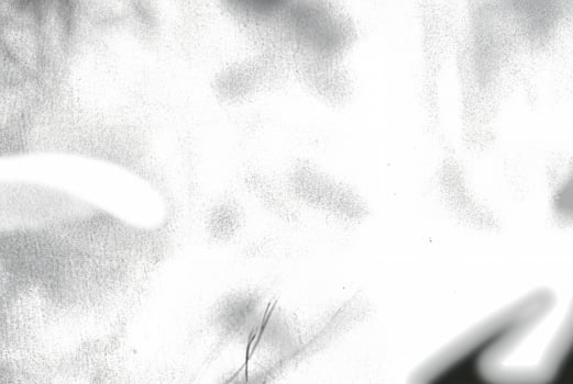 An abstract texture with an overexposed appearance, showing faint shadows in soft, indistinct forms. photo