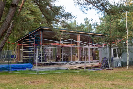 Construction site of wooden house surrounded by scaffolding photo