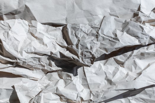 A textured background of crumpled white paper symbolizing chaos and creativity, perfect for concepts of recycling or brainstorming photo