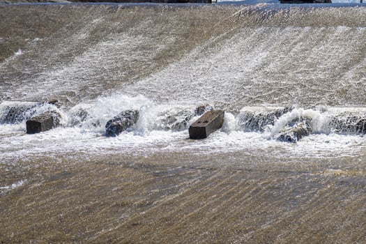 chute dentate blocks in concrete water spillway channel photo