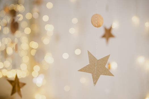 A New Year's Christmas garland sparkles against the background of a white wall. A garland in the shape of circles and stars. Winter New Year holidays. photo