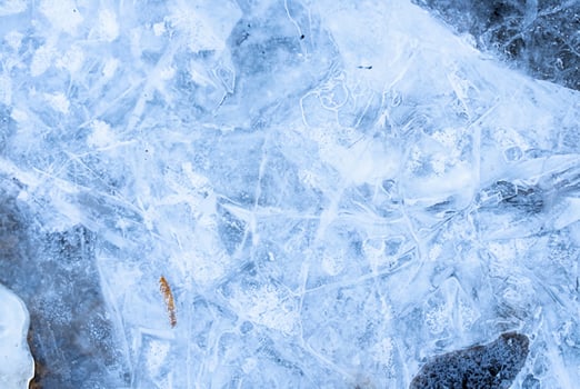 Detailed close-up of a frozen ice surface featuring intricate crystalline patterns, perfect for winter-themed backgrounds. photo