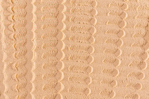 Chic cosmetic background texture of loose dry powder. beautiful lines of light tone powder texture. layout, design. Symmetrical Abstract Pattern. photo