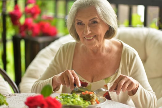 Portrait of a beautiful elderly woman dining outdoors photo
