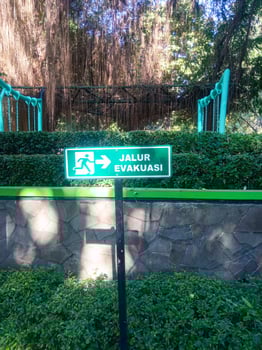 evacuation route sign in a park photo