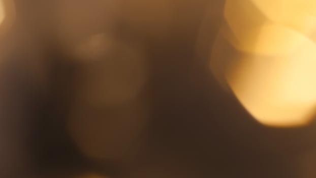 Golden bokeh festive background with soft, twinkling lights and a glowing effect photo