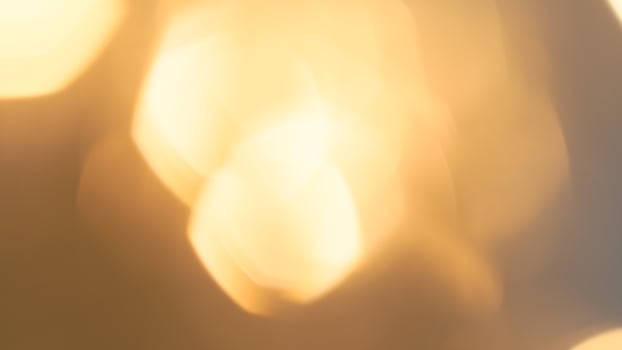 Warm glowing bokeh lights in a golden festive background for holiday celebrations photo