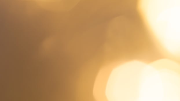 Shimmering golden bokeh lights in a vibrant holiday background with a radiant glow photo