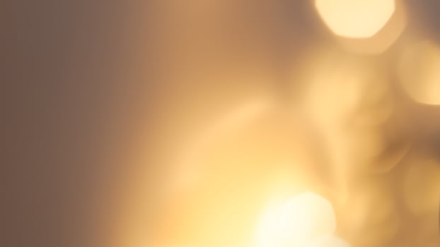 Warm glowing bokeh lights in a golden festive background for holiday celebrations photo